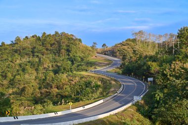 Natural background of road number three with the mountain slope views and blue sky in the morning of Nan province. Amazing Thailand. 