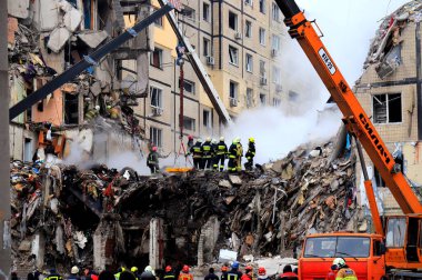 Russian missile strike on apartment building in Dnipro, Ukraine. Rocket destroyed house, rescuers are clearing rubble, looking for people. Russia war in Ukraine, Dnepr 2023-01-14