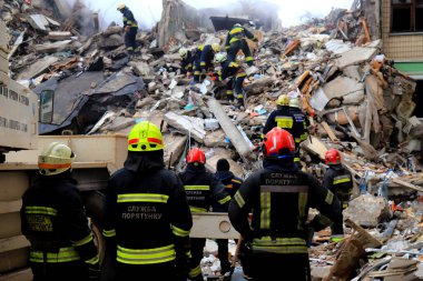 Russian missile strike on apartment building in Dnipro, Ukraine. Rocket destroyed house, rescuers are clearing rubble, looking for people. Russia war in Ukraine, Dnepr 2023-01-14