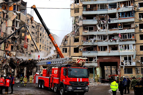 Russian missile strike on apartment building in Dnipro, Ukraine. Rocket destroyed house, rescuers are clearing rubble, looking for people. Russia war in Ukraine, Dnepr 2023-01-14
