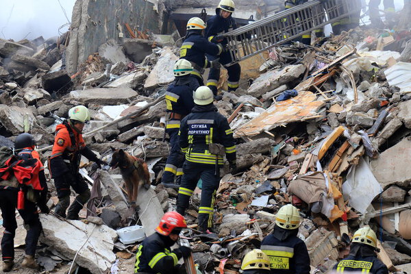 Russian missile strike on apartment building in Dnipro, Ukraine. Rocket destroyed house, rescuers are clearing rubble, looking for people. Russia war in Ukraine, Dnepr 2023-01-14
