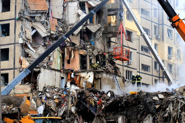 Russian missile strike on apartment building in Dnipro, Ukraine. Rocket destroyed house, rescuers are clearing rubble, looking for people. Russia war in Ukraine, Dnepr 2023-01-14