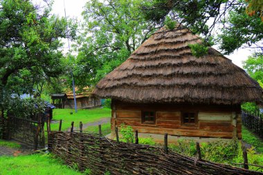 Old wooden house under thatched roof in Ukraine. Traditional rural residential Ukrainian house. Uzhgorod Ukraine
