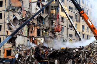 Russian missile strike on apartment building in Dnipro, Ukraine. Rocket destroyed house, rescuers are clearing rubble, looking for people. Russia war in Ukraine, Dnepr
