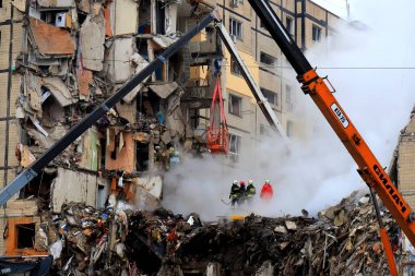 Russian missile strike destroyed residential building, Dnipro, Ukraine. Rescuers are looking for people under rubble of house, rescue equipment, fire. Russian war in Ukraine, Dnepr 2022-01-15