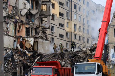 Russian missile strike destroyed residential building, Dnipro, Ukraine. Rescuers are looking for people under rubble of house, rescue equipment, fire. Russian war in Ukraine, Dnepr
