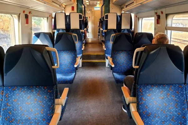 Passenger car in train with blue seats. Passenger rail transport, transportation, travel, tourism