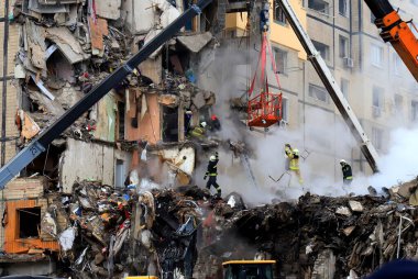 Russian missile strike destroyed residential building, Dnipro, Ukraine. Rescuers are looking for people under rubble of house, rescue equipment, fire. Russian war in Ukraine, Dnepr