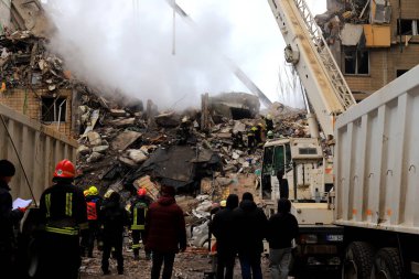 Russian missile strike on apartment building in Dnipro, Ukraine. Rocket destroyed house, rescuers are clearing rubble, looking for people. Russia war in Ukraine, Dnepr 2023-01-14