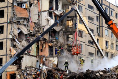 Russian missile strike destroyed residential building, Dnipro, Ukraine. Rescuers are looking for people under rubble of house, rescue equipment, fire. Russian war in Ukraine, Dnepr