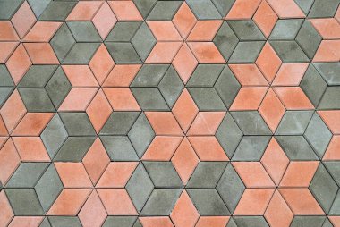 Kaldırımlar, patika, güzel modern kaldırım levhalarından yapılmış yol, geometrik desenler. Soyut gri turuncu arka plan, çimento taş levhaları dokusu. Döşeme, cadde, ev için malzeme yakın çekim