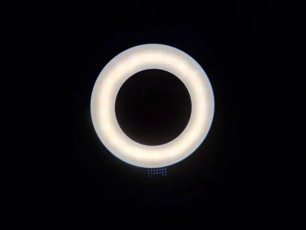 Ring-shaped cool white LED lights illumination against a dark backdrop