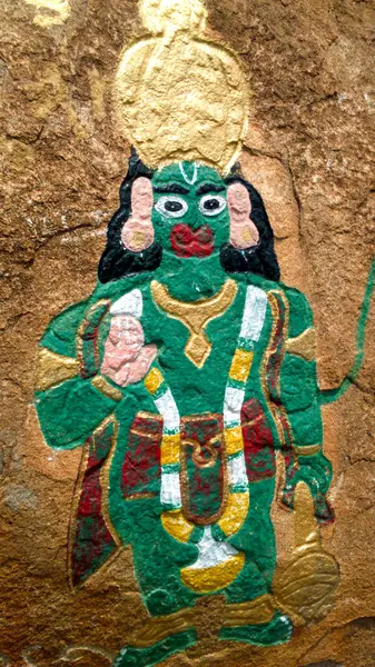 stock image A painting of Hanuman on a rock, perched atop a hill at Kaivara Thathayya in Karnataka