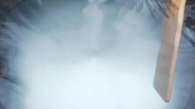 Kafkasyalı kız dışarıda sıcak bir banyo hazırlıyor, Yeni Zelanda - yaşam tarzı konsepti