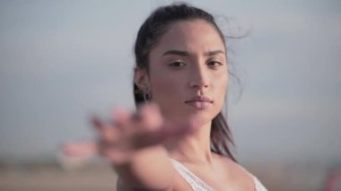 Kız elini kaldırıyor ve Playa Malvarrosa 'da gökyüzüne bakıyor.