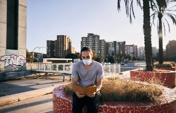 Caucasian Boy Gray Shirt Face Mask Sitting Urban Park Reading — Stock Photo, Image