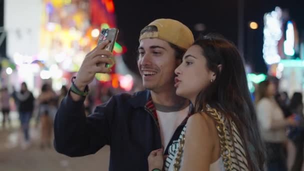 Young Couple Looking Mobile Phone Crowd Amusement Park Spanish Fair — Stock Video
