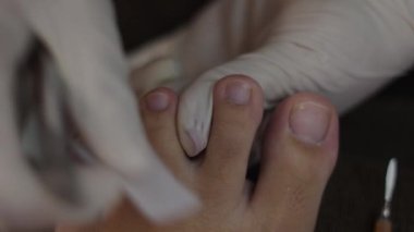 Macro Close up of nail trimming by a pedicure professional - Health concept