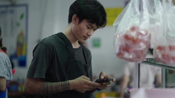 Genç Thai Sokak Yemekleri Satıcısı Akıllı Telefon Teslimat Uygulamasını Kontrol — Stok video