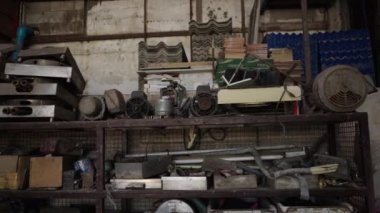 Traveling shot of unorganized tools in a factory - 4K Horizontal video