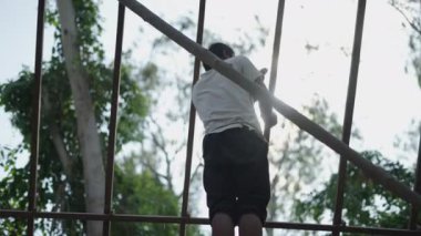 Young laborer hammering nails into a wooden roof in Koh Tao, Thailand - 4K Horizontal video