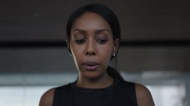 Close up of an african american woman using ear phones to stream while running in a treadmill - Lifestyle concept
