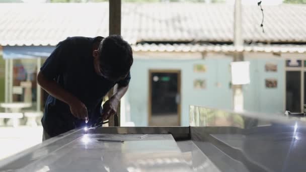 Young Asian Man Welding Two Metals Together Smiling Camera Horizontal — Stock Video