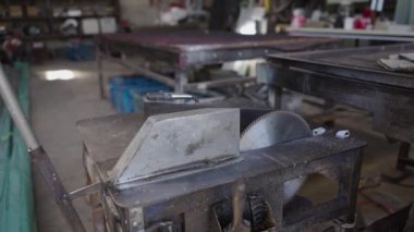 Close up shot of an angle grinder in a metal factory in Koh Tao, Thailand - 4K Horizontal video