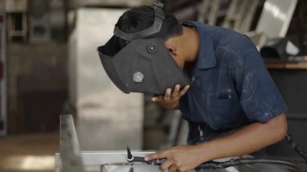 Молодой Азиатский Сварщик Надевает Защитный Шлем Сварку Горизонтальное Видео — стоковое видео