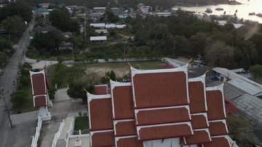 Tilt up view of a temple surrounded by nature in koh tao island - Drone shot