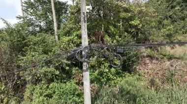 Close up shot of dangerous wires on a pylon in thailand - Drone shot