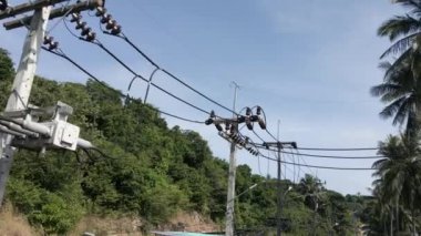 Pylons and electricity distribution of a natural and beautiful island - Drone shot