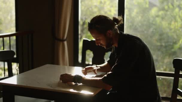 Homem Adulto Com Rabo Cavalo Desenhando Algo Uma Tabuleta Mesa — Vídeo de Stock