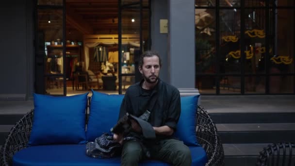 彼のタブレットと美しい現代庭に座っている西洋の男 オンラインワーカー — ストック動画