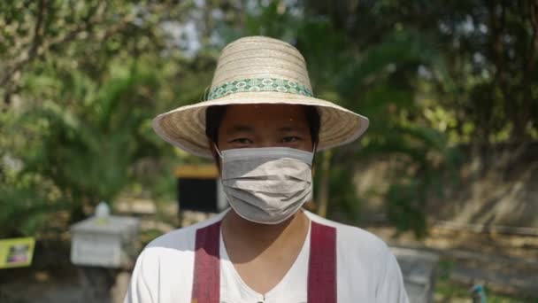 帽子とマスクを被るアジアの養蜂家を閉じる エコロジーのコンセプト — ストック動画