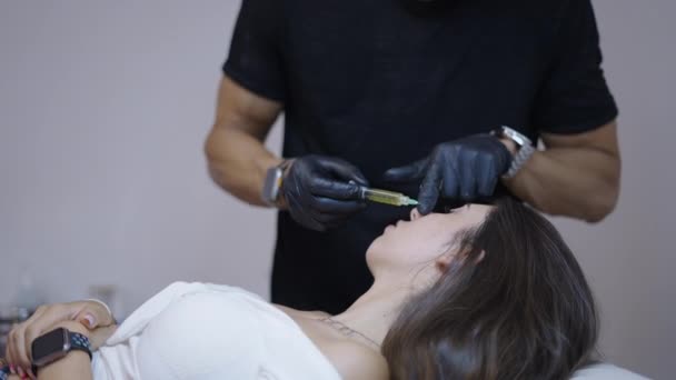 美しい患者は抽出されたPrp 4K水平ビデオで医師によって顔に注入されます — ストック動画