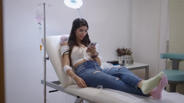Caucasian Patient Stretcher While Looking Her Phone Seeing Something Funny — Stock Video