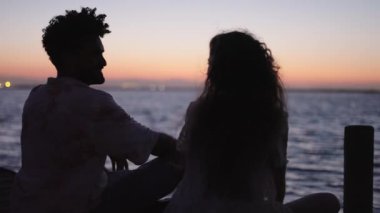 Çiftler güzel bir günbatımında birbirlerine sevgi gösterirler - 4K Yatay video