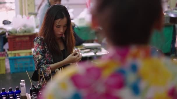 Smiling Asian Girl Tests Air Freshener Market Horizontal Video — Stock Video