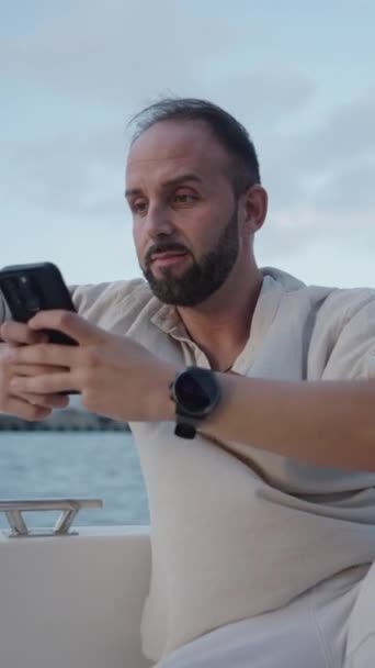 European Guy Looking His Phone While Sailing Vertical Fhd Luxury — Stock Video