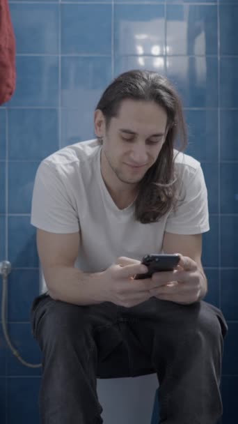 Young Caucasian Man Using His Phone Bathroom While Shit Frontal — Video