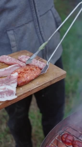 无法辨认的人把肉放在烤架上 美味健康的食物 Fullhd垂直录像 — 图库视频影像