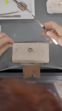 Stüdyoda çalışan küçük bir kadın kuyumcunun en iyi görüntüsü. Tepeden Çekilen FullHD Dikey Video