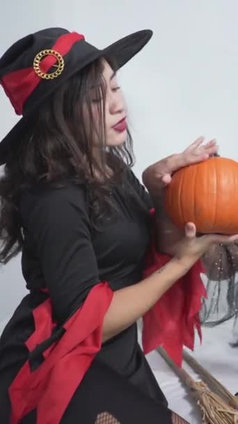 Two Beautiful Women Wearing Black Witch Dress Hat Holding Pumpkin — Stock Video