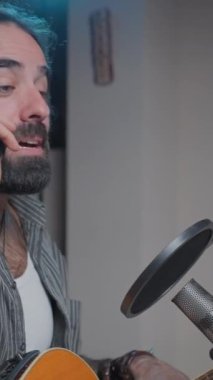Music influencer talking with his phone at his home studio - Slow motion middle shot