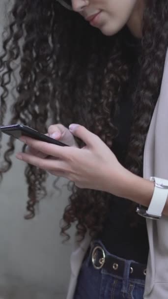 Curly Haired Moroccan Lady Smiling While Looking Her Smartphone Sideview — Stock Video