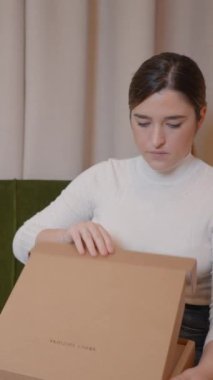 Karton kutularda satıcı ürünleri paketliyor - müşterilere teslimat için paketler hazırlıyor, evden çalışıyor - Dikey FullHD video