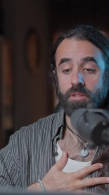 Handsome bearded vocal coach teaching online to his YouTube audience the different kind of voices that exist - Close up shot