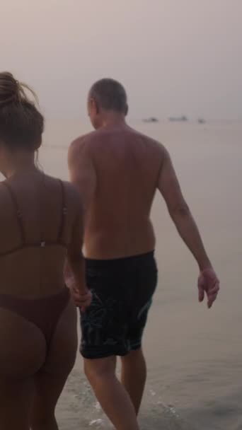 Two Lovers Enter Water Holding Hands Fhd Vertical — Stock Video