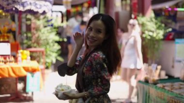 Güzel kadın dondurmasını taşırken gülümsüyor - 4K Yatay video